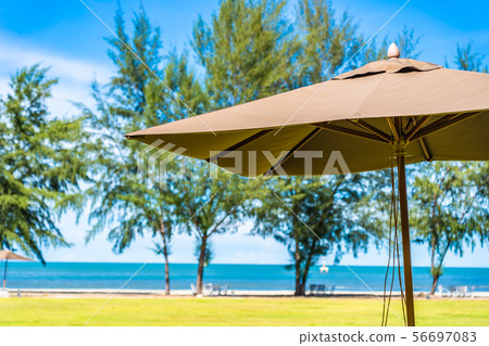 Beautiful outdoor landscape of sea and beach with umbrella and chair around there Beautiful outdoor landscape of sea and beach with umbrella and chair around there 56697083