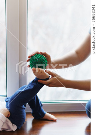 Mother makes foot massage to child. 56698341