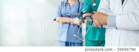 Doctor working in hospital with other doctors. 56698790