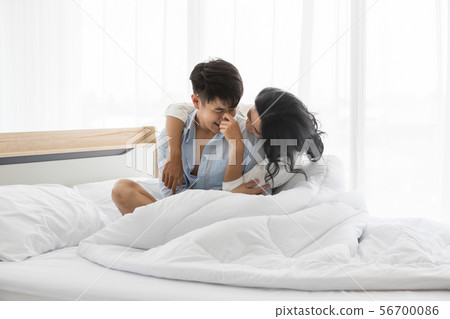 Couple sits on bed, they hug each other by love.. 56700086