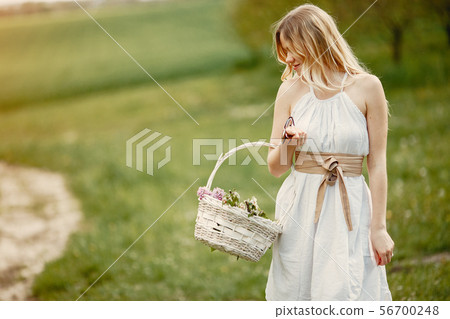 Elegant and stylish girl in a spring park Elegant and stylish girl in a spring park 56700248