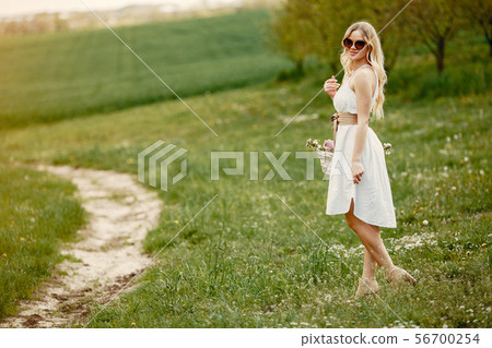 Elegant and stylish girl in a spring park Elegant and stylish girl in a spring park 56700254
