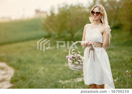 Elegant and stylish girl in a spring park Elegant and stylish girl in a spring park 56700259