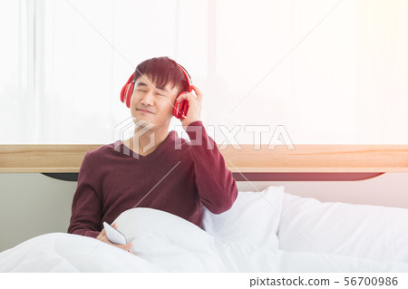 Asian man listen to music by headphone in 56700986