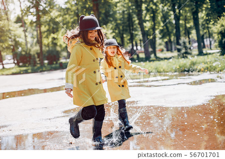 Cute kids plaiyng on a rainy day 56701701