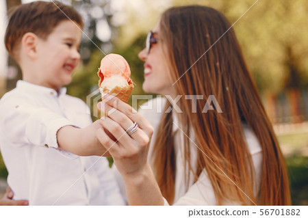 Mother with son playing in a summer park Mother with son playing in a summer park 56701882