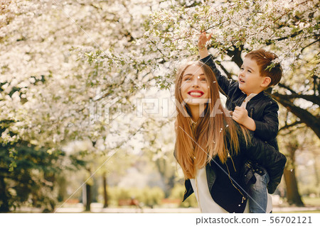 Mother with son playing in a summer park Mother with son playing in a summer park 56702121