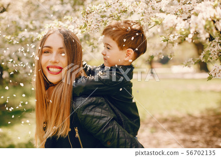 Mother with son playing in a summer park Mother with son playing in a summer park 56702135