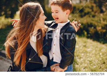 Mother with son playing in a summer park Mother with son playing in a summer park 56702704