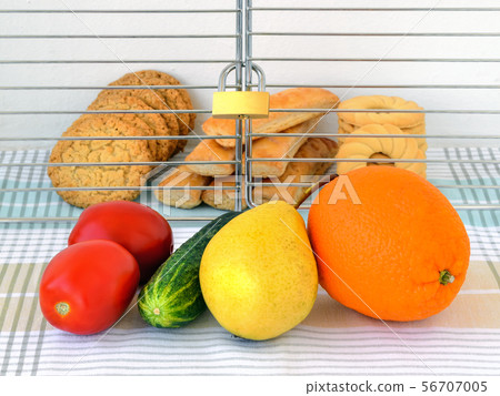 Sweet cookies are in a cage locked with padlock. 56707005