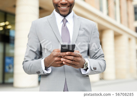 Businessman typing a message Businessman typing a message 56708285