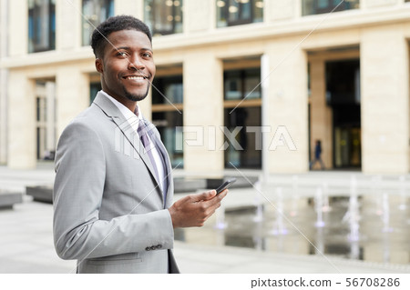 Successful businessman with phone Successful businessman with phone 56708286