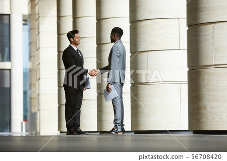 Business partners meeting outdoors Business partners meeting outdoors 56708420