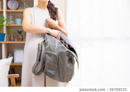 Pregnant woman with backpack Pregnant woman with backpack 56709535