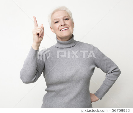 Perfect idea. Elderly Woman Pointing Finger Up, Got Problem Solution Perfect idea. Elderly Woman Pointing Finger Up, Got Problem Solution 56709933