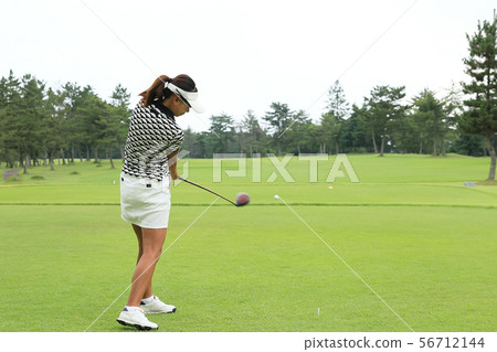 Woman hitting the tee shot Woman hitting the tee shot 56712144