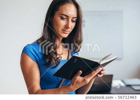 English class Female student read notes from notebook. 56712463