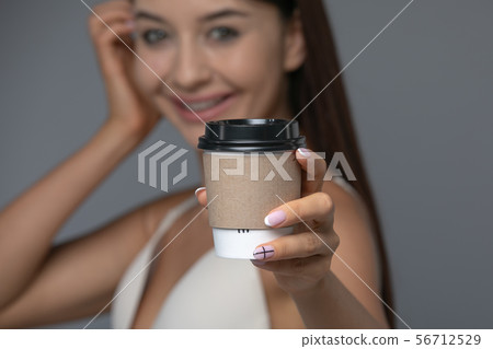 Take Away White Paper Hot Coffee Cup With Right Hand Holding. 56712529