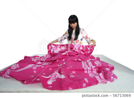 Cute Asian Girl Changing Clean Bed Sheet. Cute Asian Girl Changing Clean Bed Sheet. 56713069
