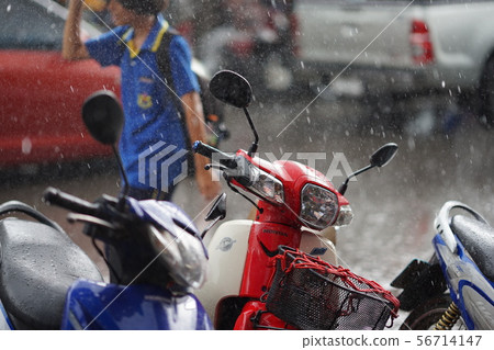 A woman rushing ahead of Southeast Asian specialty squall 56714147