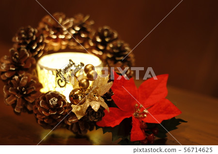 Christmas image, candle and poinsettia and pine cone wreath 56714625