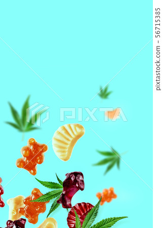 Colored gummies fly along with cannabis leaves. Food concept with CBD oil, THC Colored gummies fly along with cannabis leaves. Food concept with CBD oil, THC 56715385