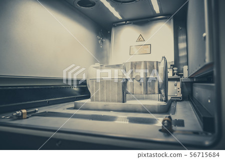 Model with supports created in laser sintering machine stays in working chamber Model with supports created in laser sintering machine stays in working chamber 56715684