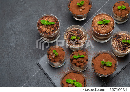 Group of portions of Classic tiramisu dessert in a glass cup on stone board on concrete background 56716684