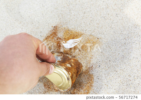 an old rusty tin can left by a man on a sandy 56717274