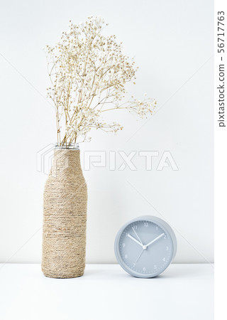 Classic alarm clock and flower branch in a vase Classic alarm clock and flower branch in a vase 56717763