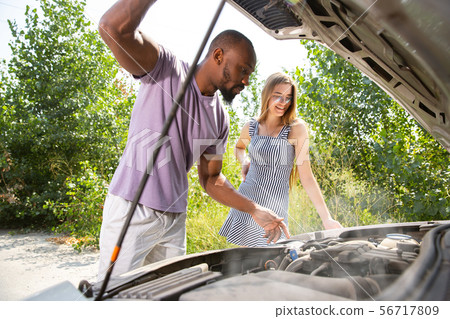 Young multiethnic international couple traveling on the car in sunny day 56717809