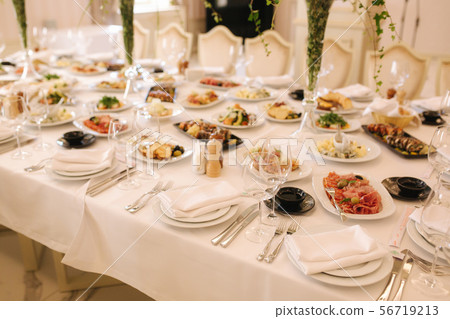 Table with mixed food. Banquet in restaurant, table setting. Differend meals for the guests. Fresh Table with mixed food. Banquet in restaurant, table setting. Differend meals for the guests. Fresh 56719213