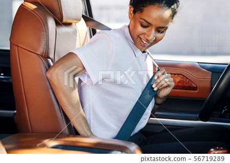 Young businesswoman fastening her seat belt  56719289