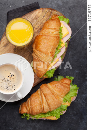 Coffee, orange juice and croissant sandwich Coffee, orange juice and croissant sandwich 56719775