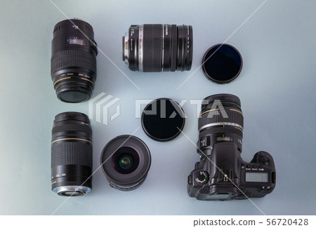 Camera, lenses and filters on blue background Camera, lenses and filters on blue background 56720428