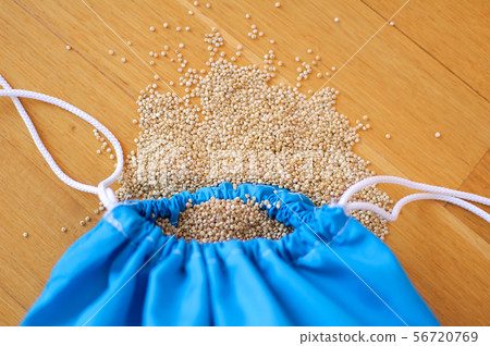 White quinoa seeds in transparent blue reusable bag on wooden background. Vegetarian food concept 56720769