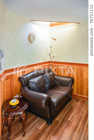 Luxury brown leather loveseat in the corner under the sunroof Luxury brown leather loveseat in the corner under the sunroof 56721112