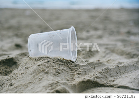 Garbage in the sea with plastic cup on beach sandy 56721192