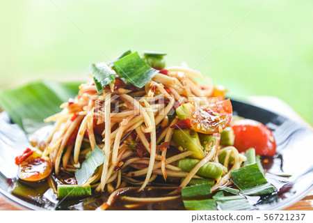 Papaya salad served on dining table - Green papaya Papaya salad served on dining table - Green papaya 56721237