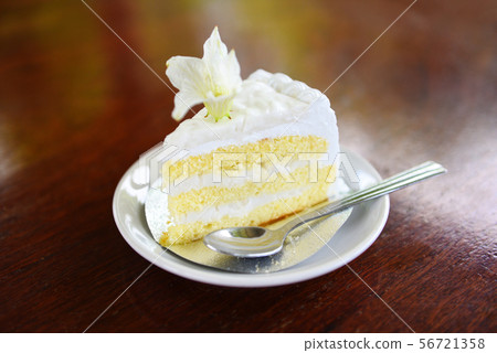 cake slice on white palte with flower on wooden cake slice on white palte with flower on wooden 56721358
