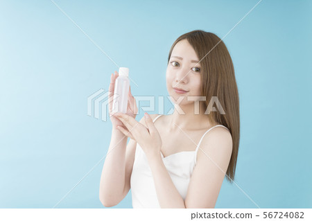 Woman with beauty bottle Woman with beauty bottle 56724082