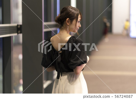 A woman in the rear 56724087