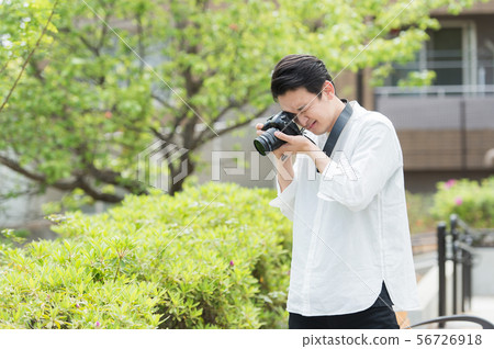 Men taking pictures outdoors 56726918