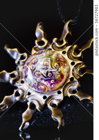 Creative shot of pendant sun made from brass and 56727983