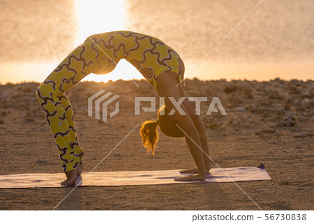 Yoga practice. Woman doing bridge pose Yoga practice. Woman doing bridge pose 56730838