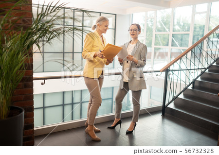 Contented Caucasian young businesswoman standing in the hall 56732328