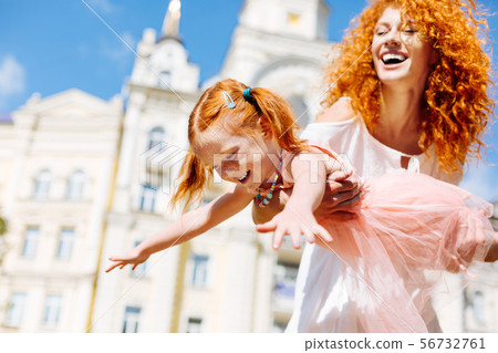 Happy red haired girl imaging that flying 56732761