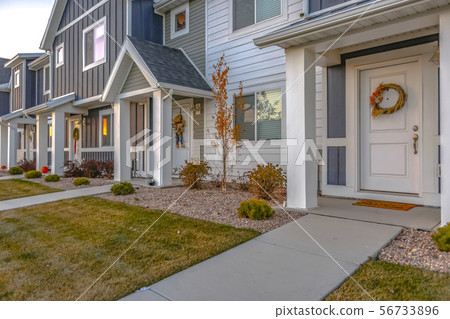 White front door of colorful townhomes with wreath White front door of colorful townhomes with wreath 56733896