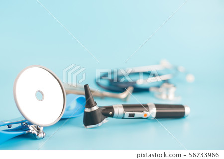 Ear instrument on blue background. Ear instrument on blue background. 56733966