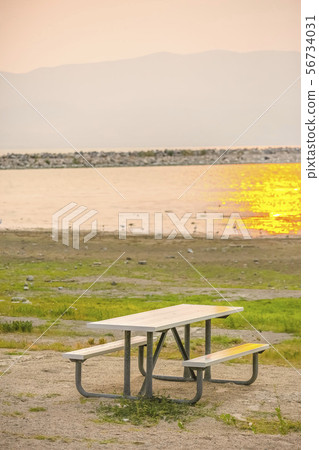 Table and bench with view of Lake Utah at sunset 56734031